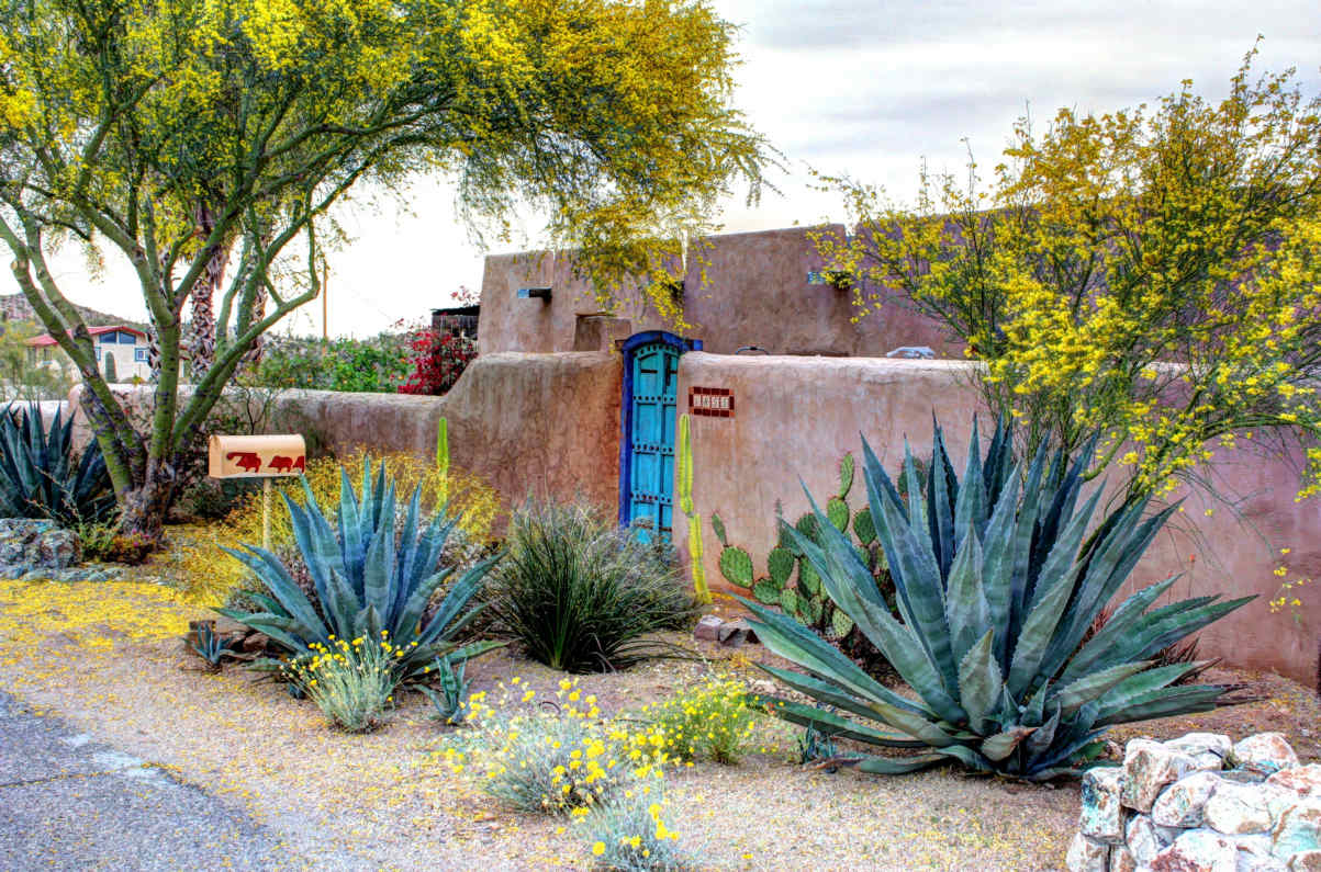 Lee Robinson 'Straw Bale House' adobe walls, with agave and the entryway